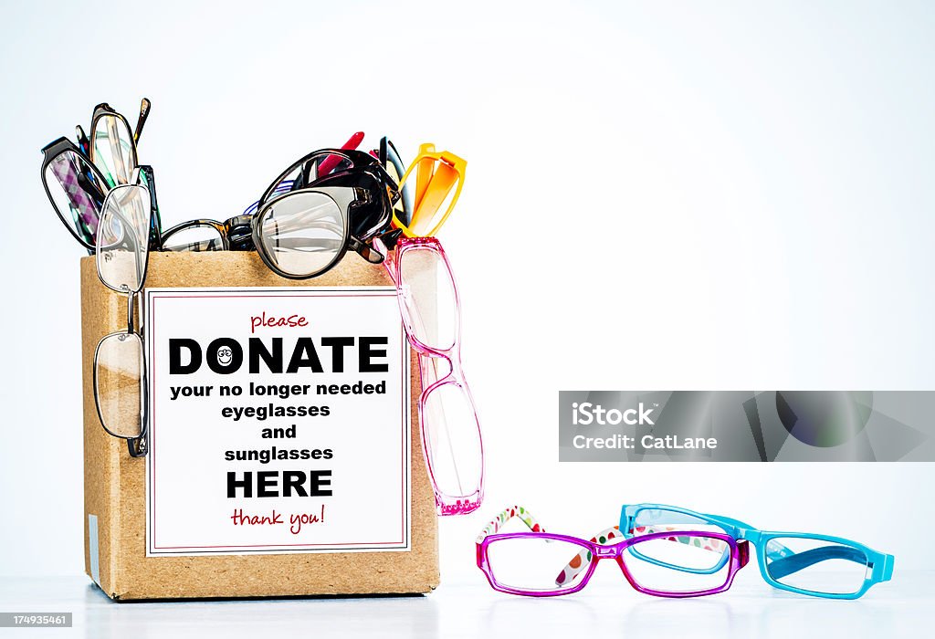 Donation box overflowing with collected eyeglasses and sunglasses